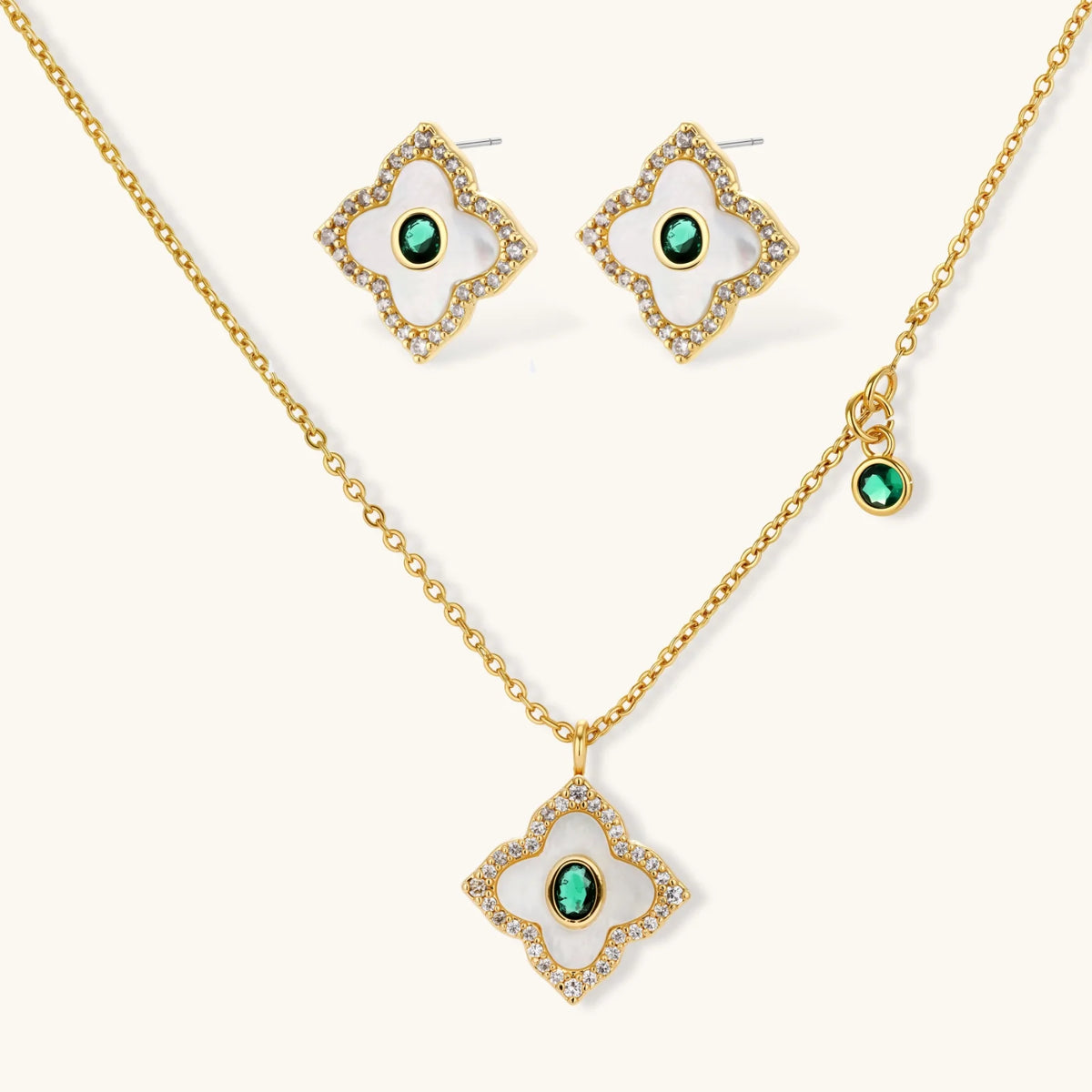Gold-plated jewelry set with diamond-shaped pendants featuring white centers, green stones, and sparkling zirconia borders