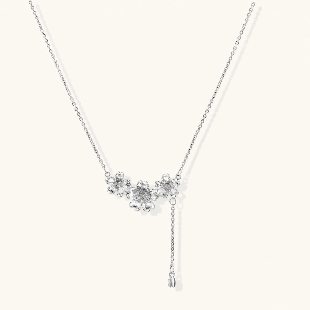 White gold plated Y-shaped necklace with three dimensional flower charms and adjustable drop pendant