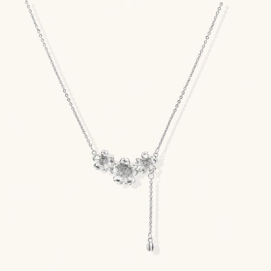 White gold plated Y-shaped necklace with three dimensional flower charms and adjustable drop pendant