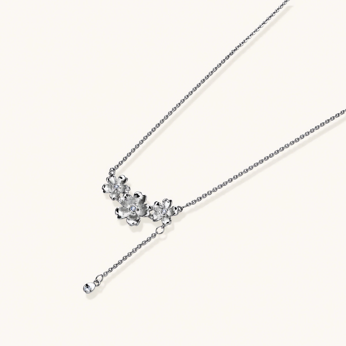 White gold plated Y-shaped necklace with three dimensional flower charms and adjustable drop pendant