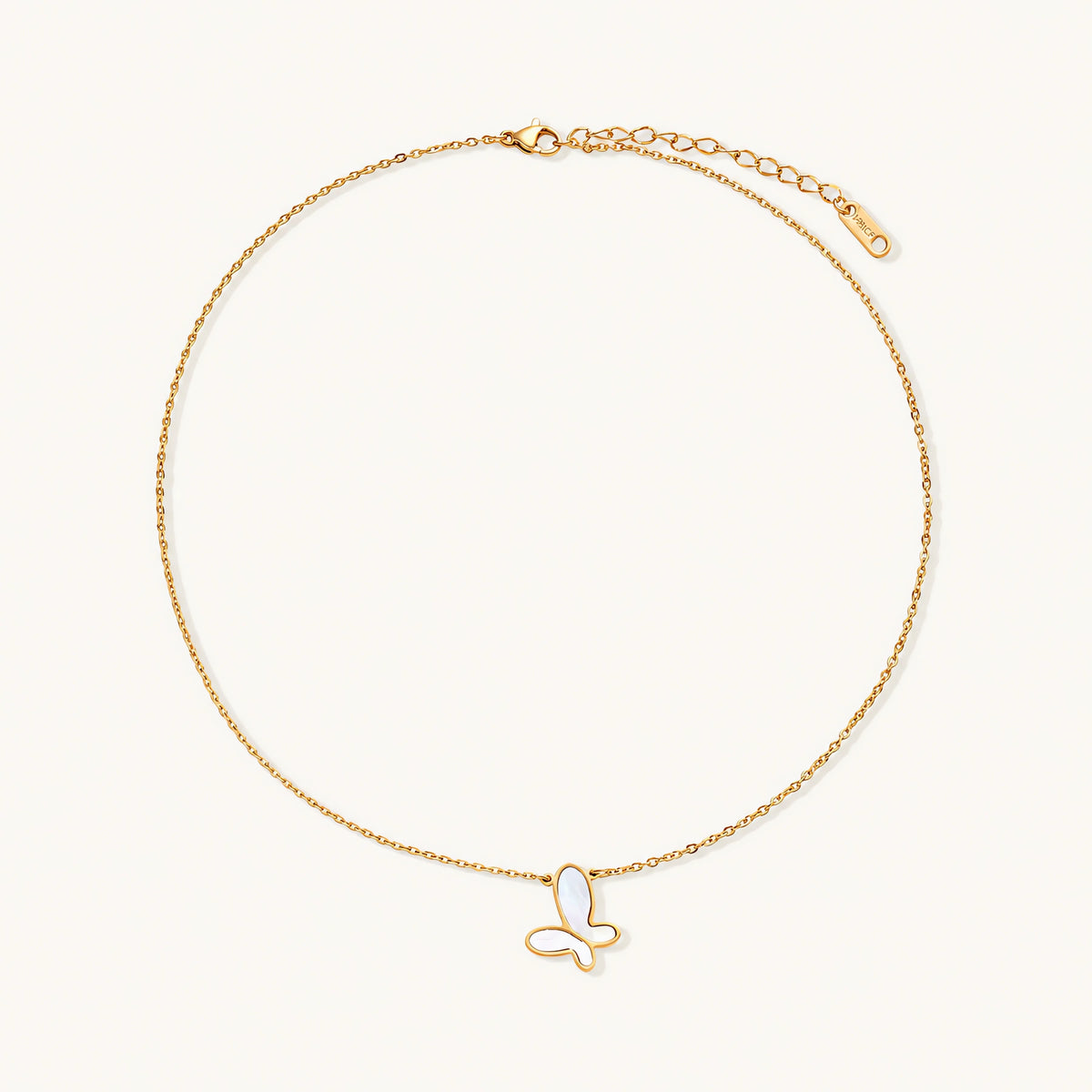 Gold-plated butterfly pendant with iridescent mother of pearl inlay on delicate chain against cream background.