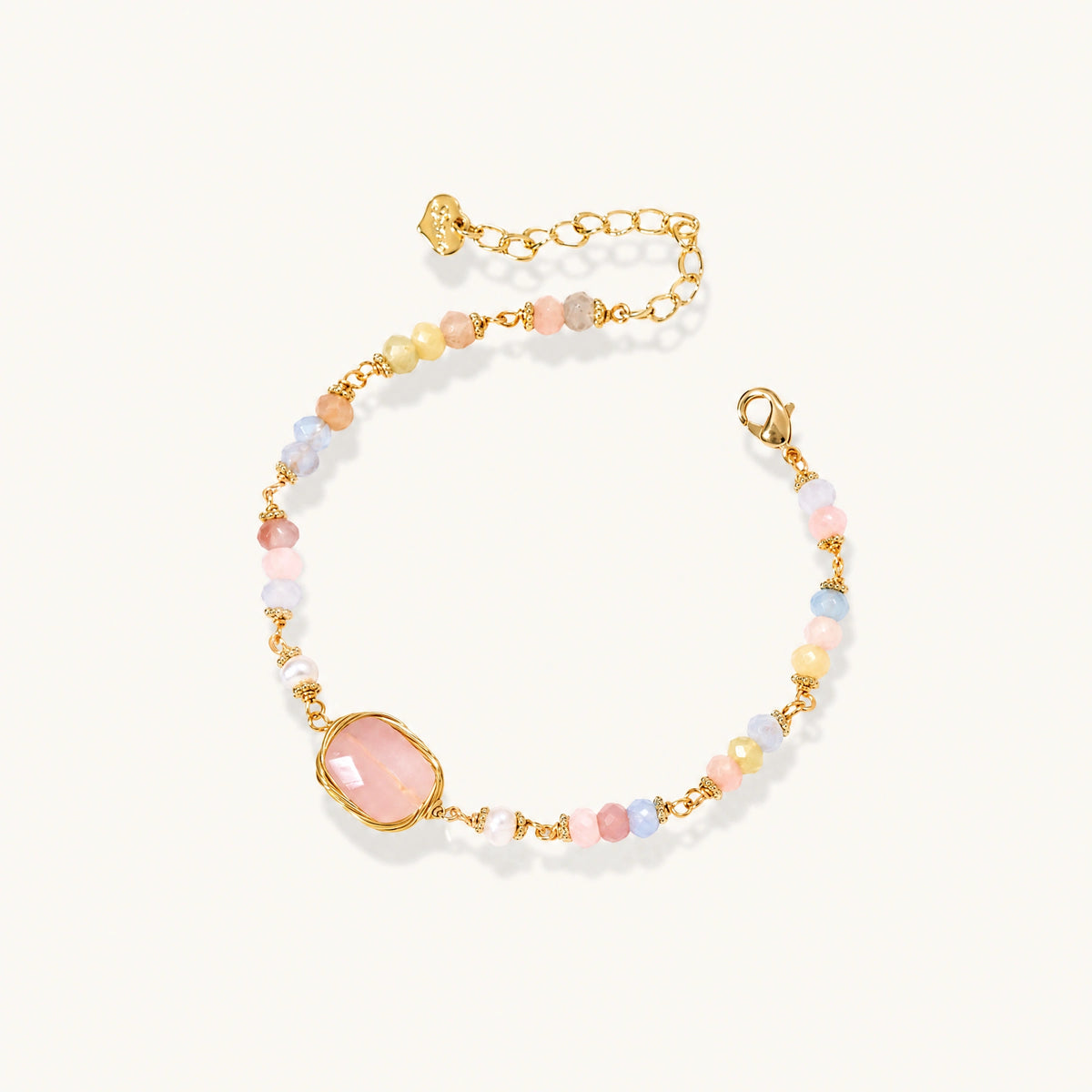 Delicate beaded bracelet with pastel rose quartz, pearls, and pink cushion-cut centerpiece in gold-plated setting